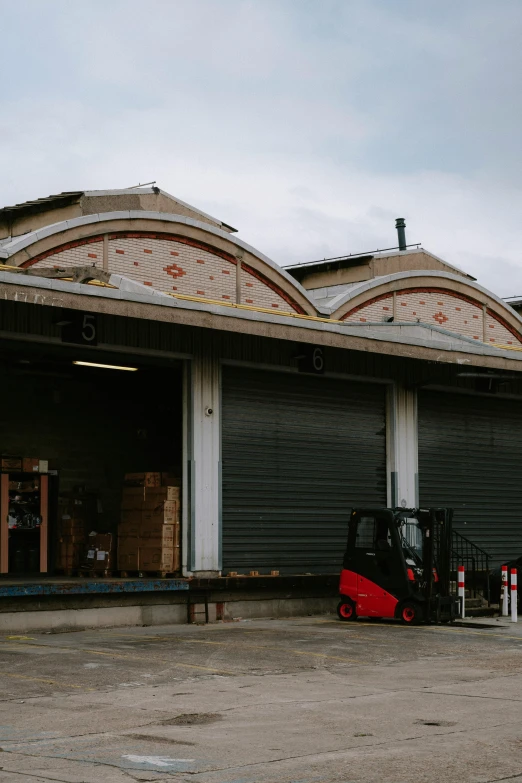 a large forklift sitting in front of a large loading dock