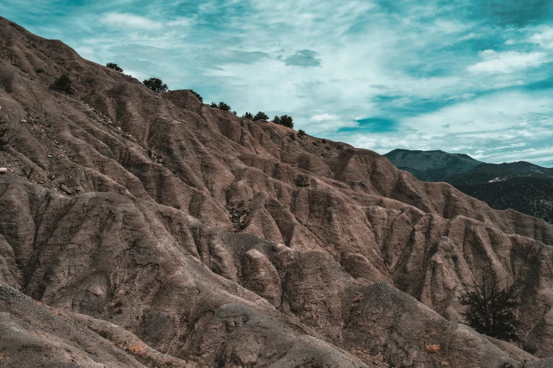 the mountain range with mountains and a few clouds