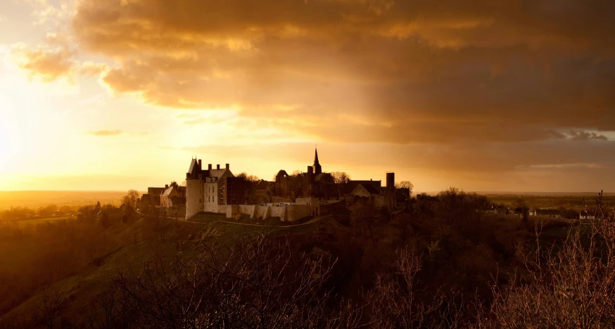 the sun is shining in front of a castle