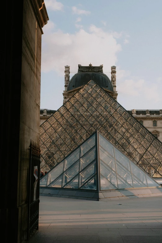 a pyramid is near two other buildings in the city