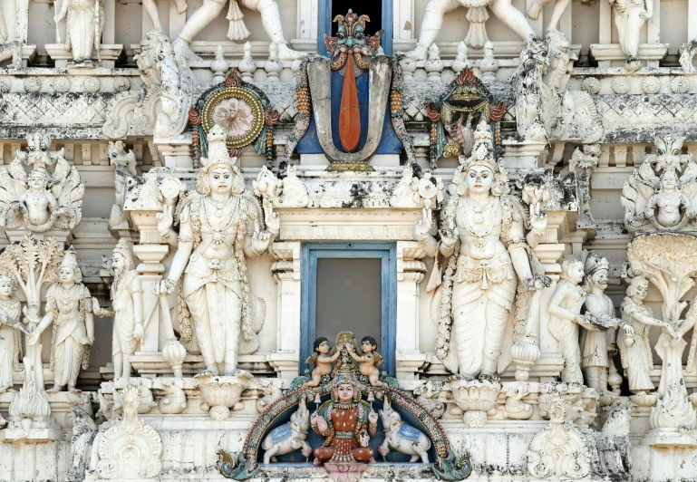 an ornate statue of the sun at one end of a window and a doorway to another side