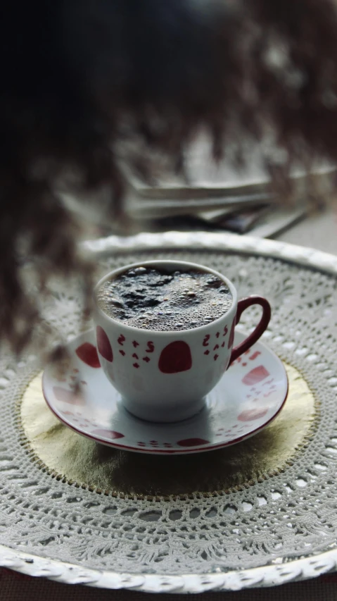 a coffee cup and saucer on a plate