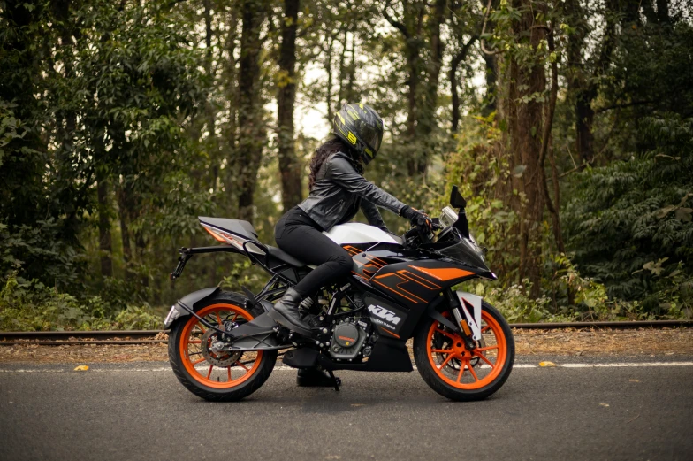 a person is sitting on a motorcycle on a road