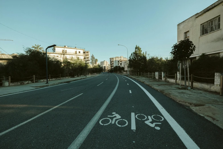 an empty street with buildings and a bike lane