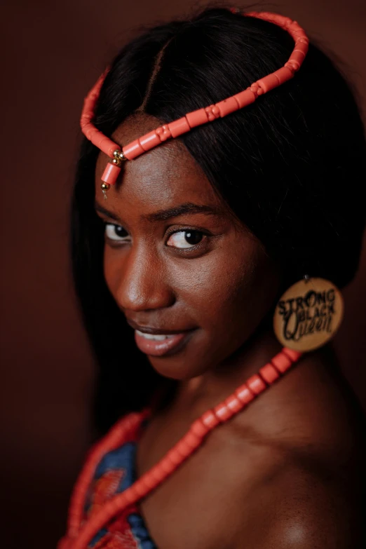 a woman is wearing some bright red necklaces