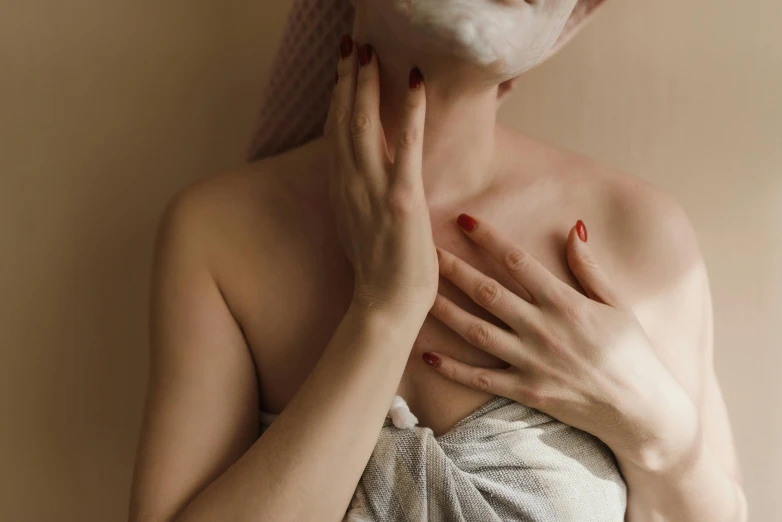 a woman with red nails posing  and having her hands underneath her body