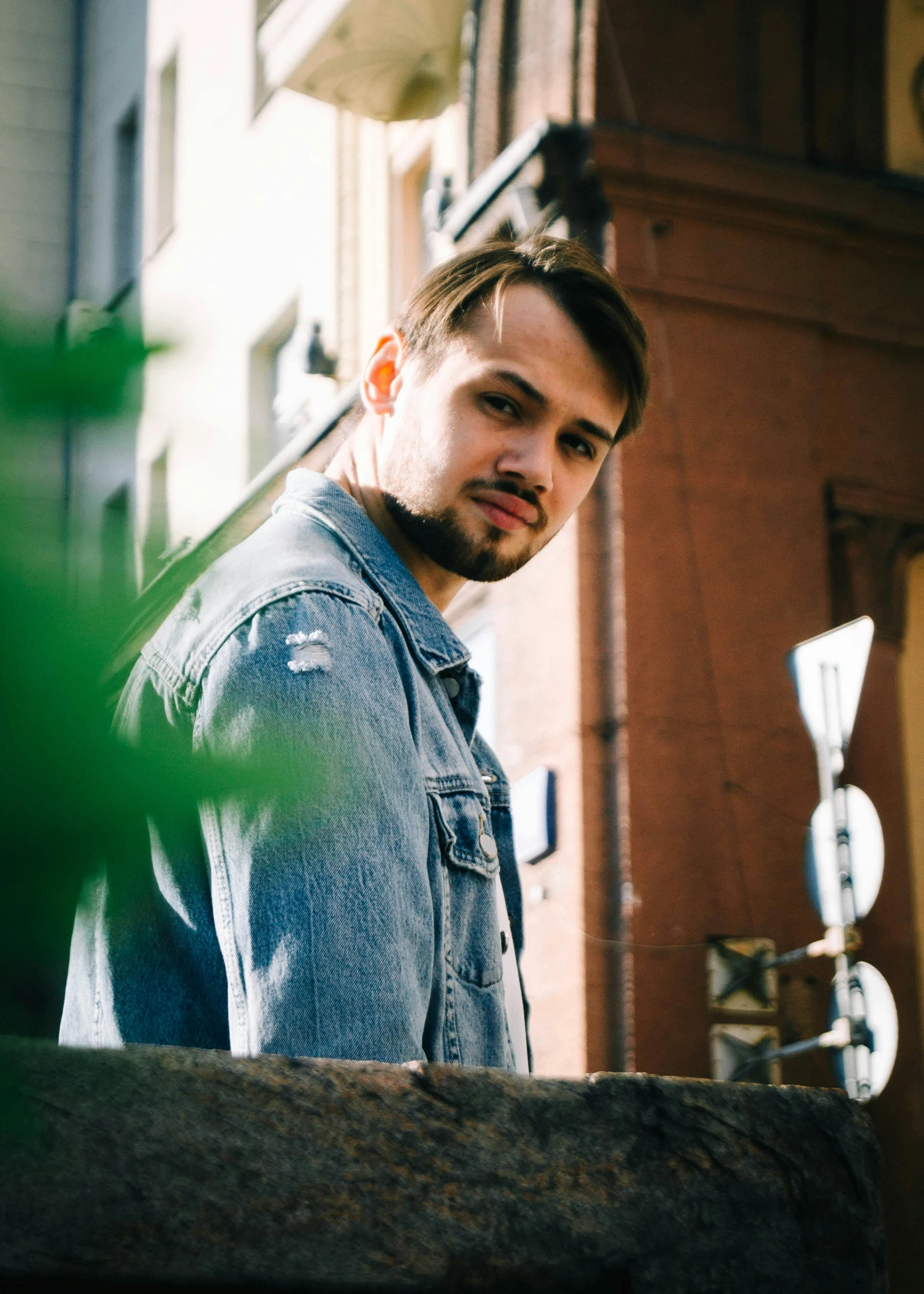 a young man stares intently in a city