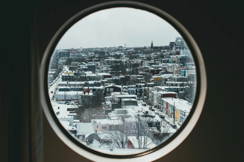 a circular mirror shows a city view of a neighborhood