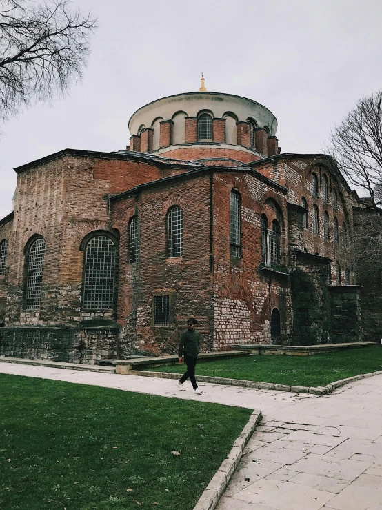 an old brick building that has a dome on top