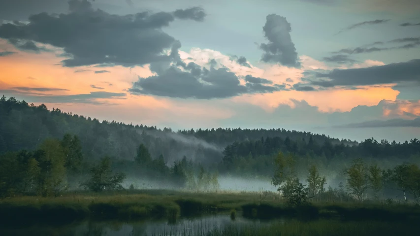 a po of a mountain, river, clouds and trees