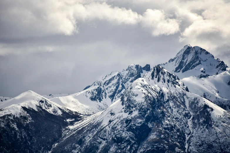 some white mountains under a cloudy sky