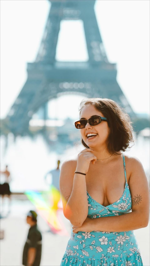 a woman is standing outside wearing sunglasses