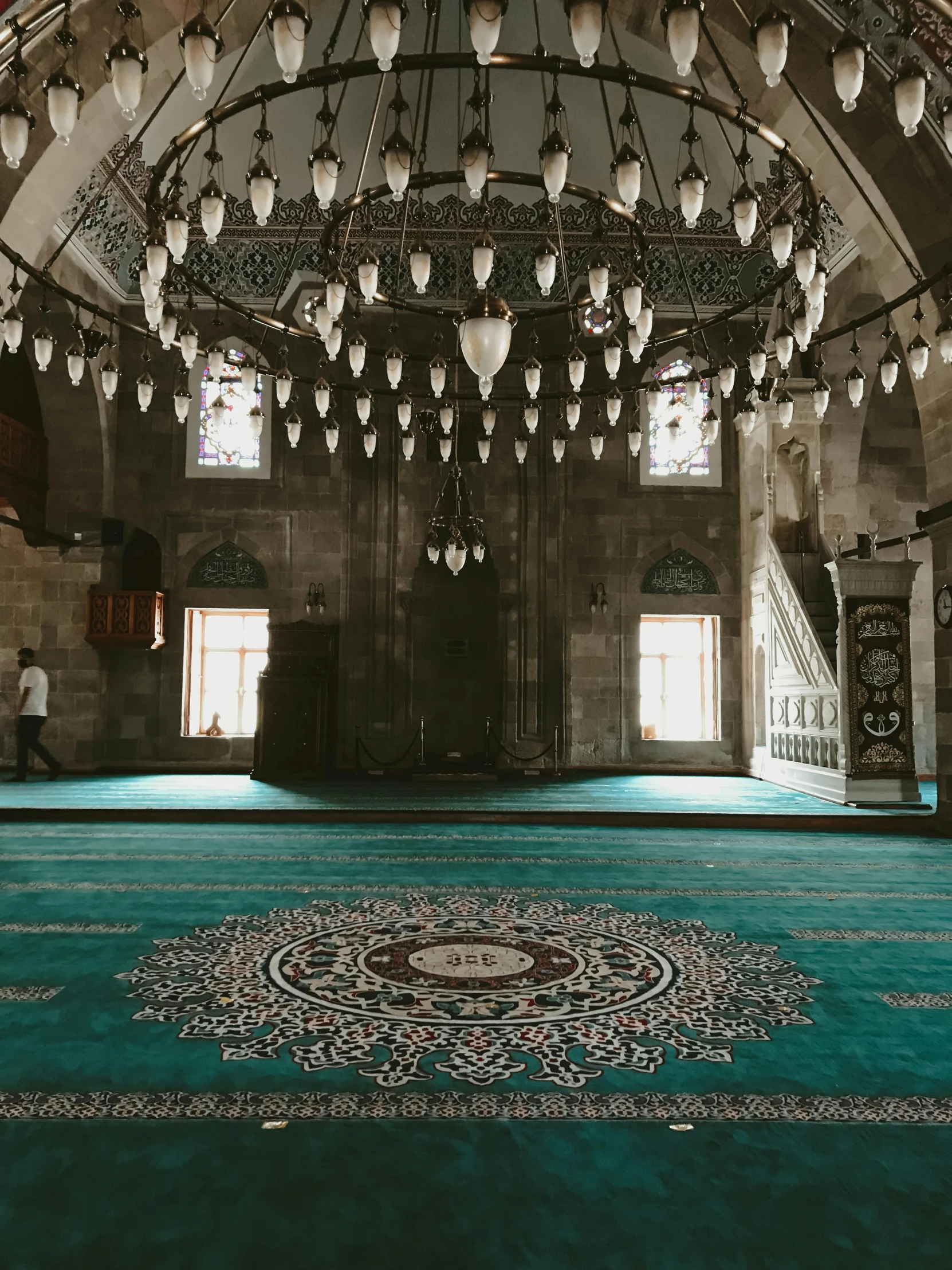 an ornate ballroom with carpet and chandelier