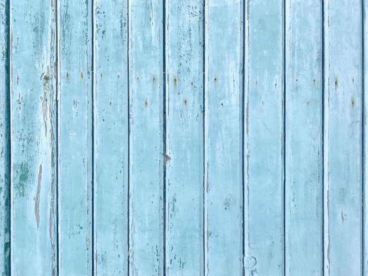 a blue wall that is very grungy with paint