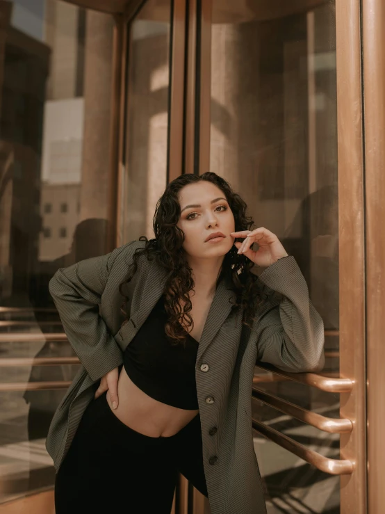 a woman in black and white jacket holding a cellphone to her ear