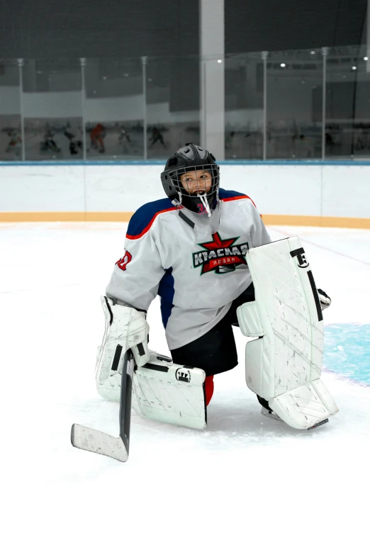 a goalie wearing a protective gear kneeling down