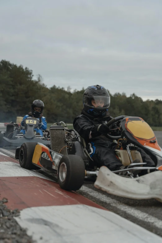 two people on a street race car