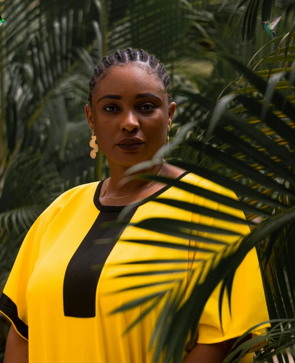 a woman in a yellow dress standing outside