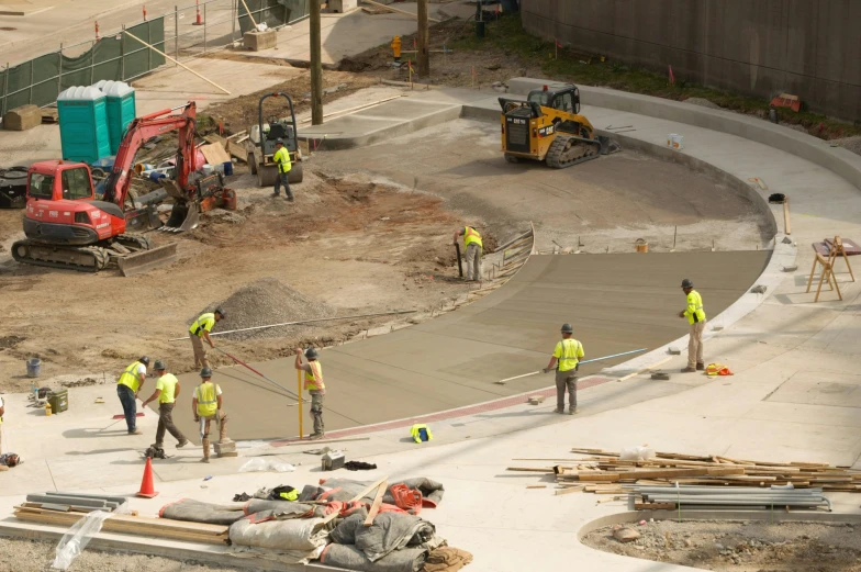 construction crew in yellow shirts working on the ground