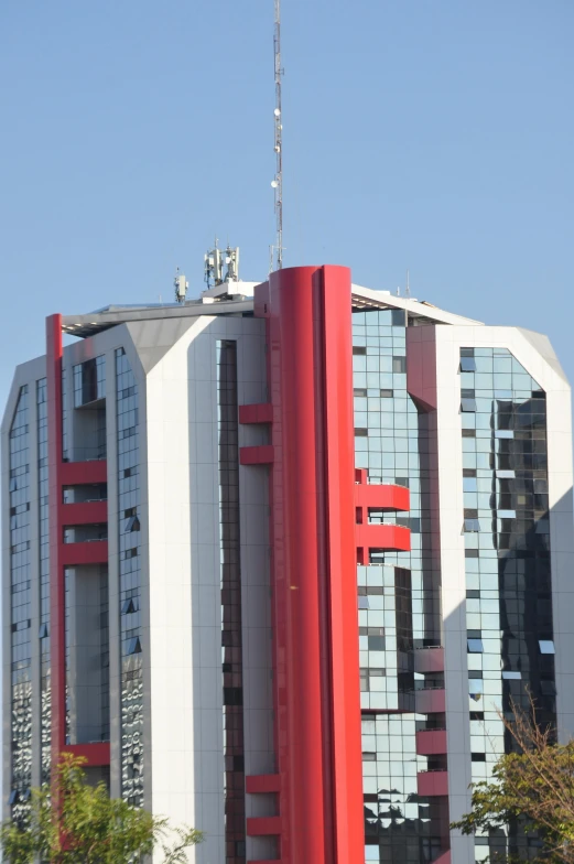 the tall building has a clock on top of it