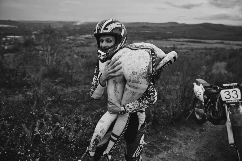 a black and white po of a person on a dirt bike