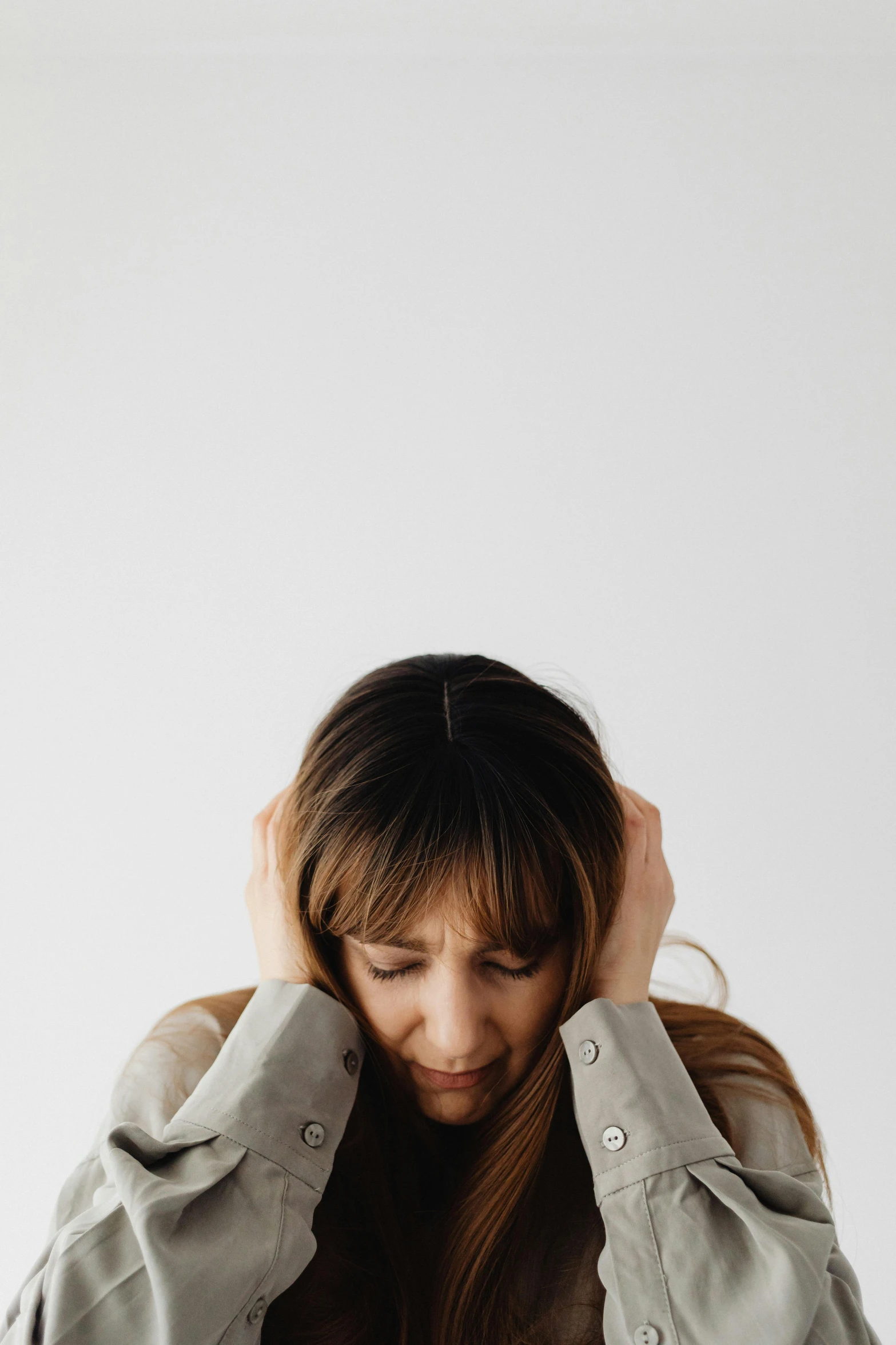 a girl is holding her head in her hands