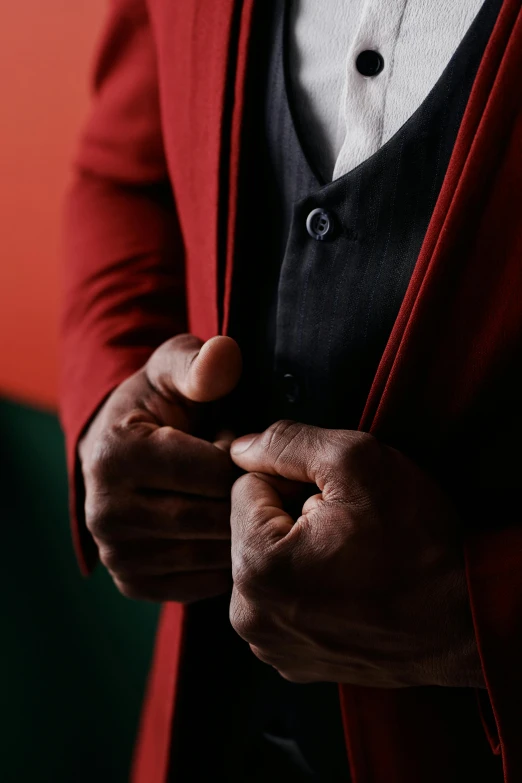a man with an open red blazer over his shirt