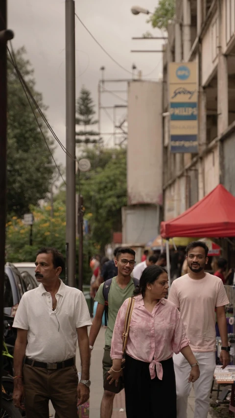 people are walking down a city street