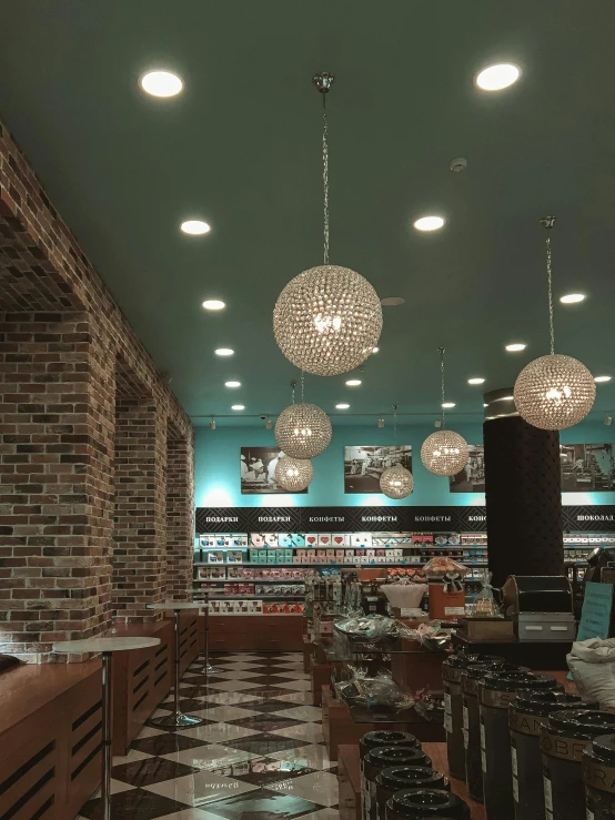 a restaurant with some lights hanging from the ceiling