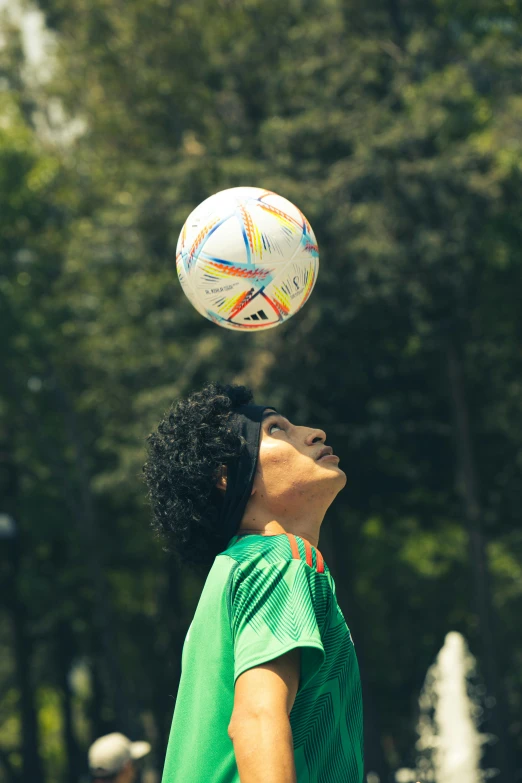 a young man is outside playing with a soccer ball