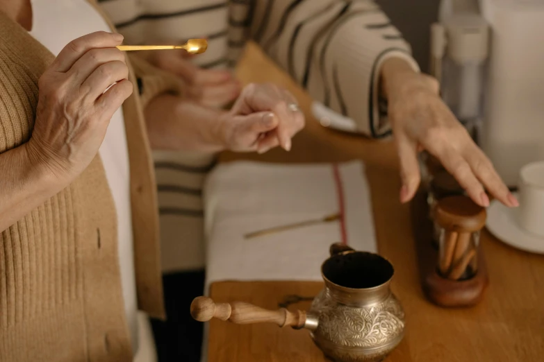 two women are sitting together at the table