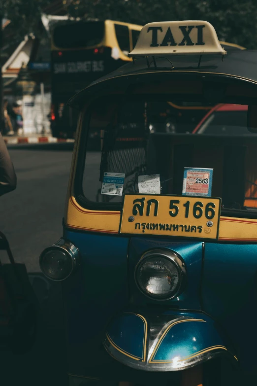 a taxi car is parked next to a parked motorcycle