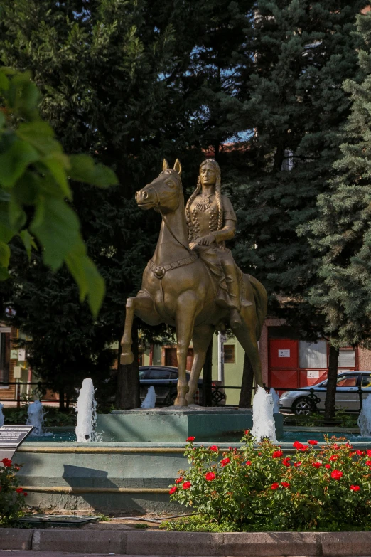 a statue of a man riding a horse in a park