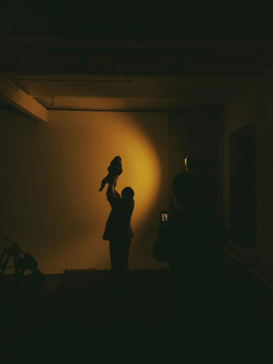 people standing near dark room in the shadows