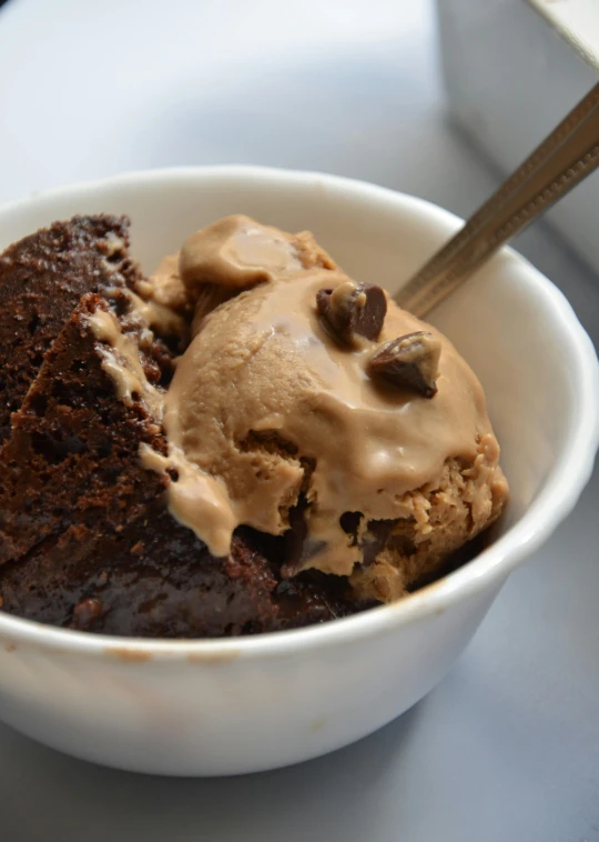 a bowl of ice cream and cookies on a table