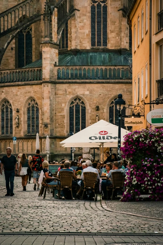 a city street that is lined with buildings and people walking through the streets