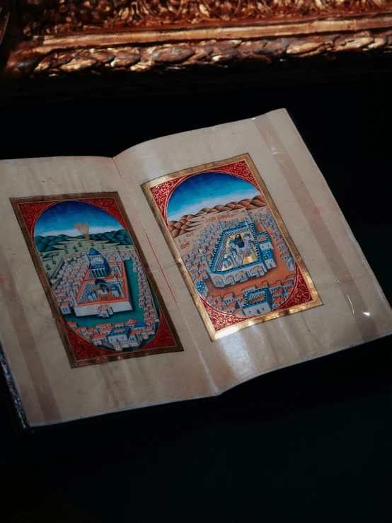two paintings are on the cover of a book