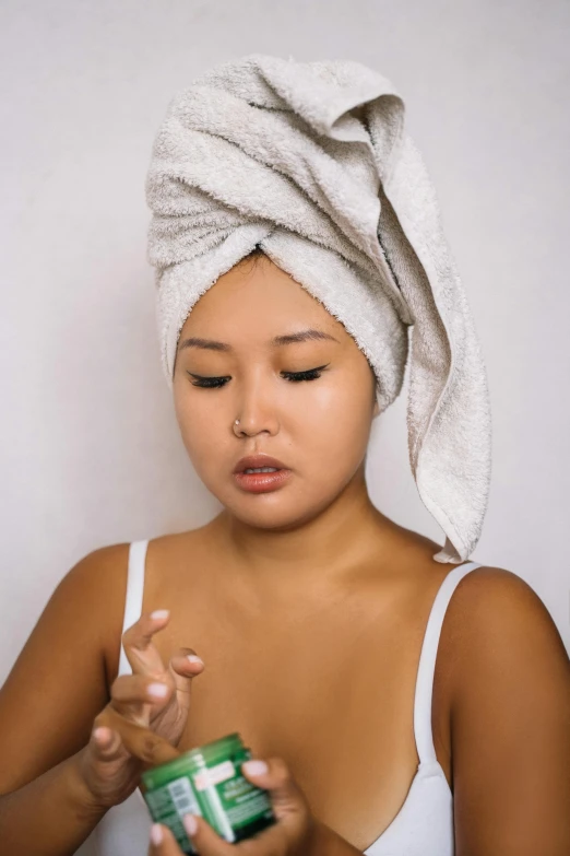 a young woman is applying her towel to dry off