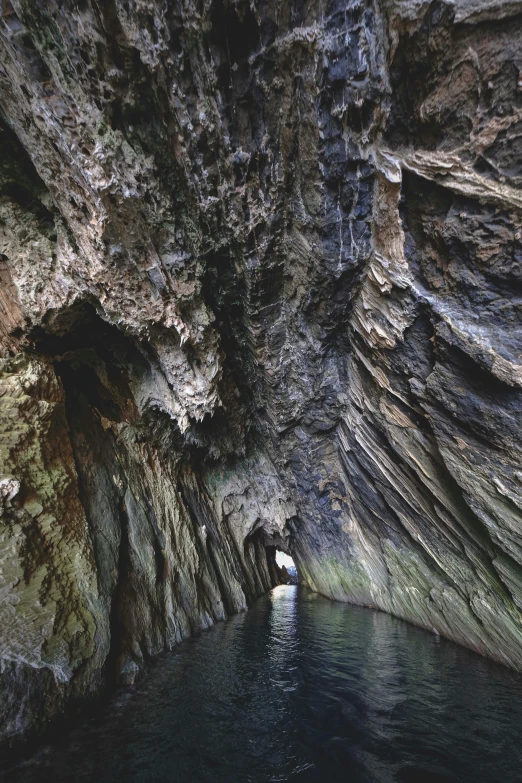 a narrow channel through an underground canyon with a man swimming