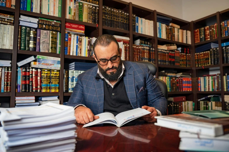 an image of a man reading at the liry