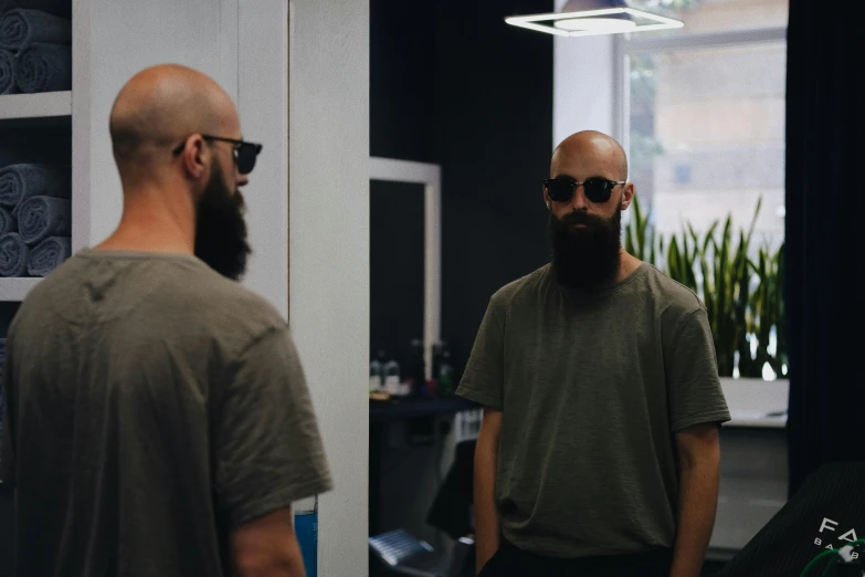 a bald man with a beard wearing sunglasses