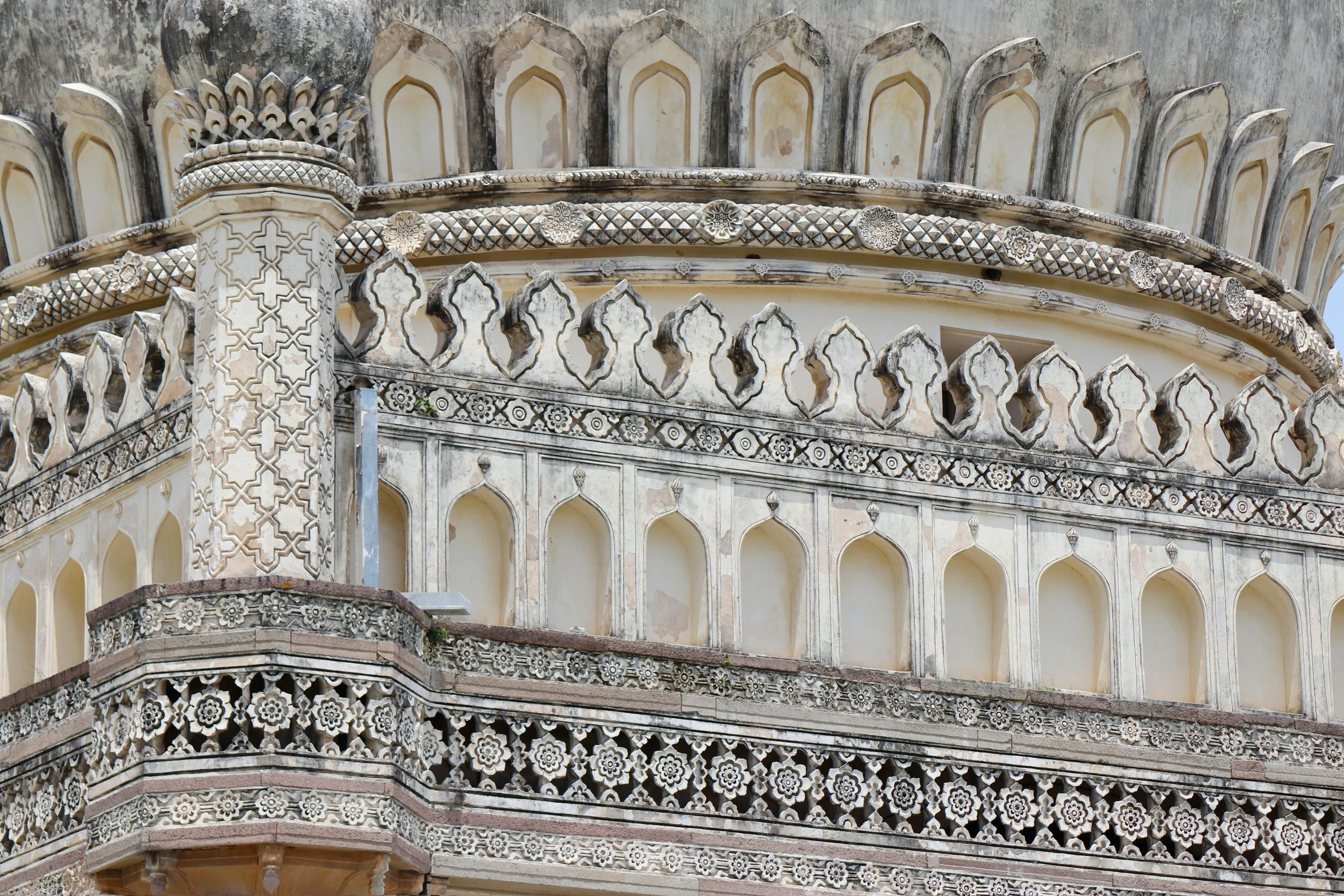an intricately decorated wall of a church with arched windows