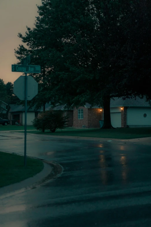 an intersection and street sign at night on a street