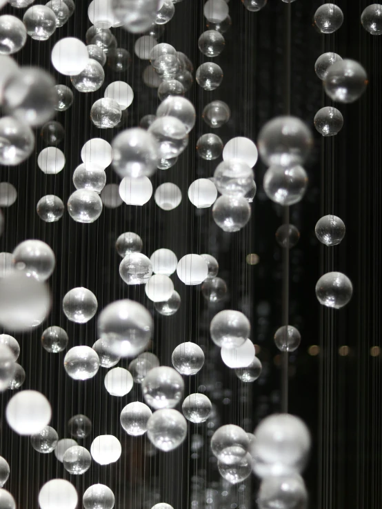 a large group of glass bubbles with a dark background