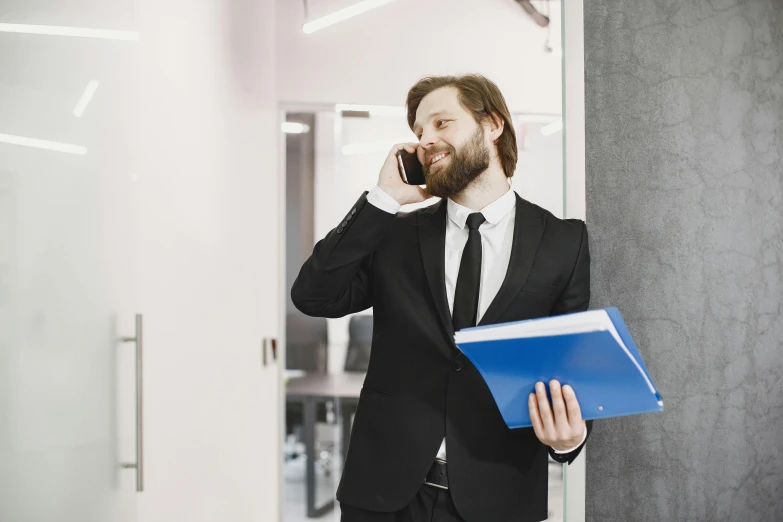 a man in a suit talking on a cell phone