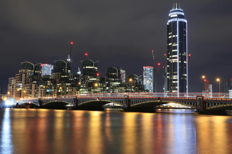 a large city with some tall buildings and water in front