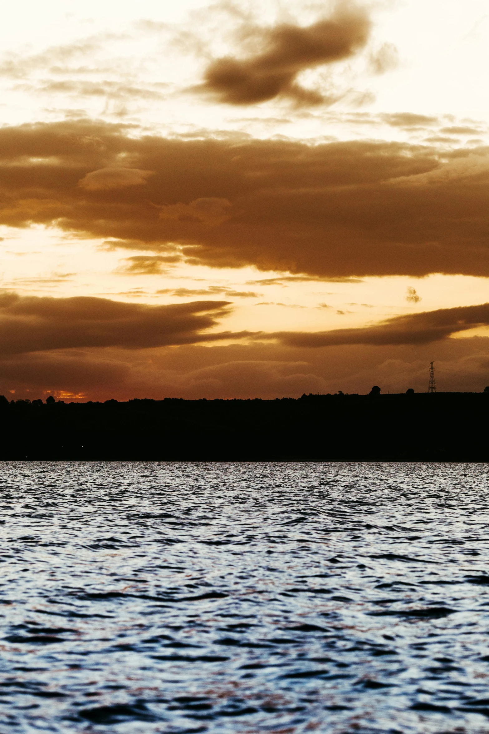 some boats and a body of water during sunset