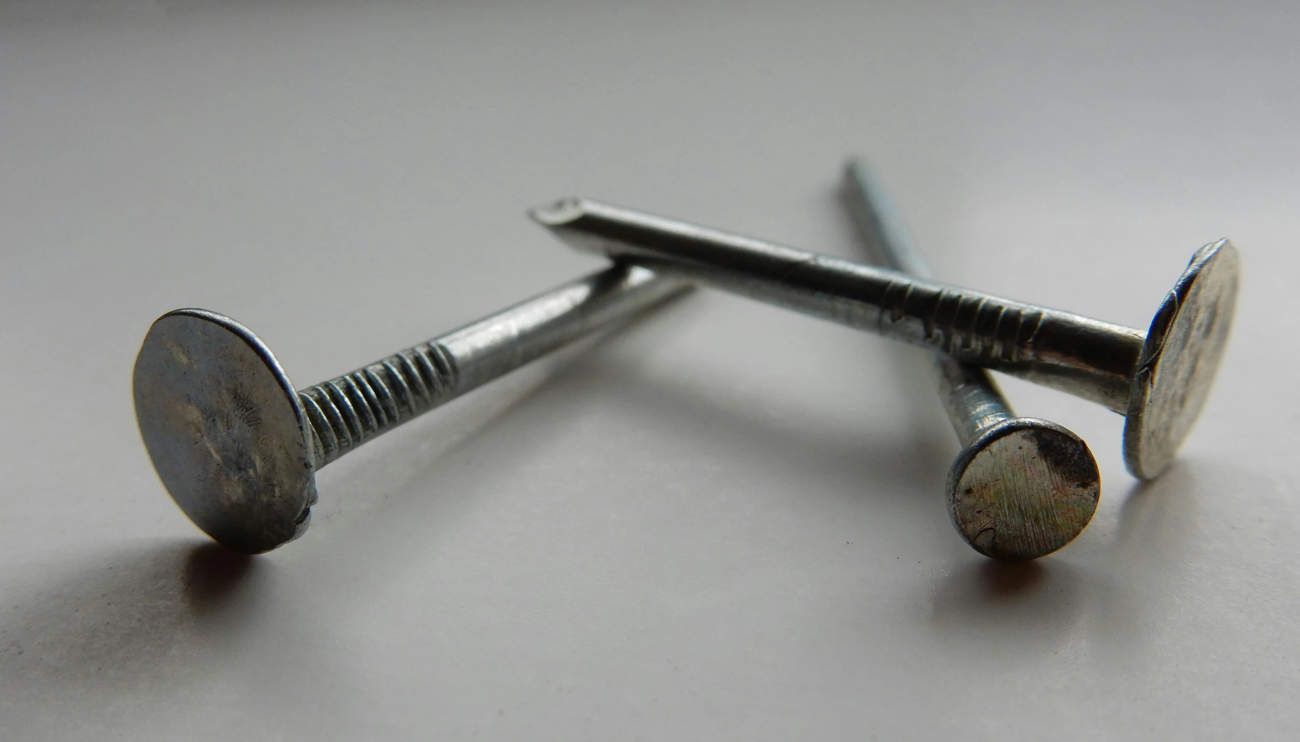 two screws are shown on a table