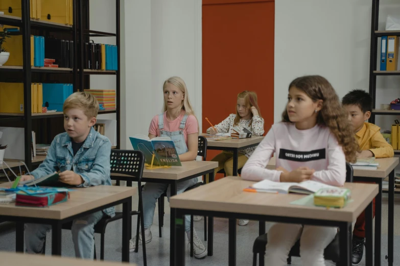 several children in a classroom all wearing different outfits