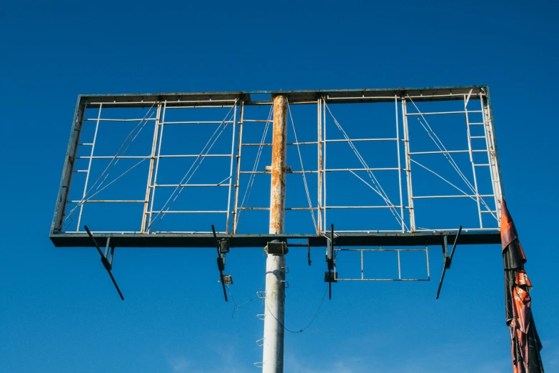 a huge billboard on a pole with a blue sky in the background